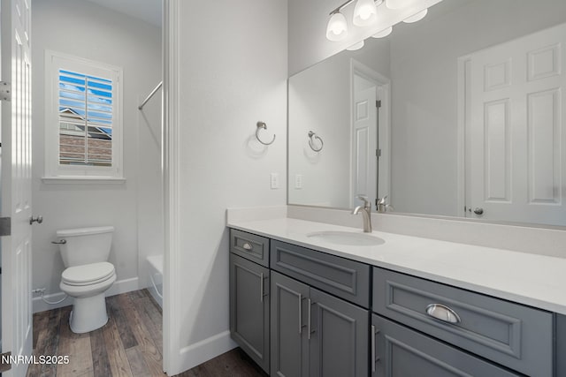 11621 Desert Shadow Dr, Sparks, NV 89441 - bathroom with vanity, wood finished floors, toilet, baseboards, and washtub / shower combination