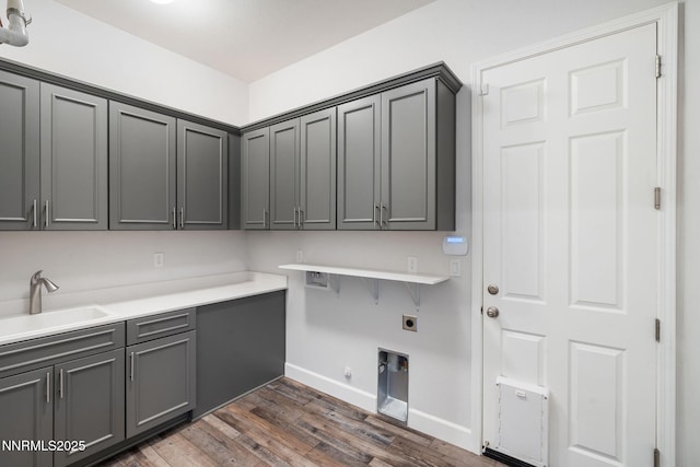 11621 Desert Shadow Dr, Sparks, NV 89441 - washroom with electric dryer hookup, cabinet space, dark wood-style floors, baseboards, and hookup for a gas dryer