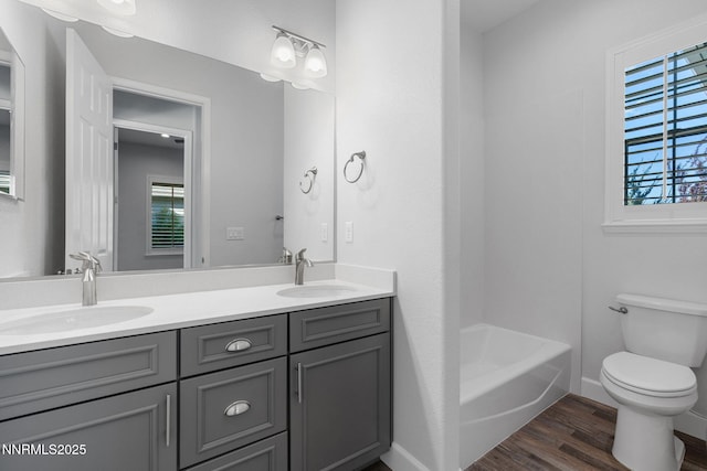 11621 Desert Shadow Dr, Sparks, NV 89441 - full bathroom with wood finished floors, double vanity, toilet, and baseboards