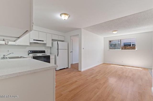 2995 Santa Ana Dr, Reno, NV 89502 - kitchen featuring freestanding refrigerator, electric stove, a sink, under cabinet range hood, and light countertops