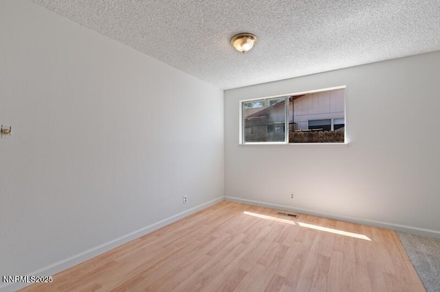 2995 Santa Ana Dr, Reno, NV 89502 - spare room featuring a textured ceiling, wood finished floors, and baseboards