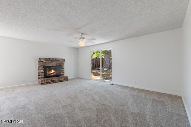 2995 Santa Ana Dr, Reno, NV 89502 - unfurnished living room featuring carpet, a ceiling fan, a brick fireplace, baseboards, and a textured ceiling