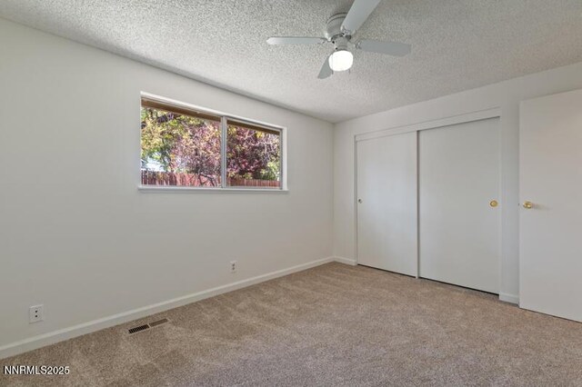 2995 Santa Ana Dr, Reno, NV 89502 - unfurnished bedroom with carpet floors, a textured ceiling, a closet, ceiling fan, and baseboards