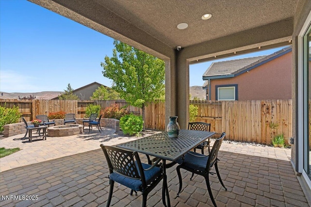 9822 Dyevera Ln, Reno, NV 89521 - fenced backyard featuring a patio area, an outdoor fire pit, and outdoor dining area
