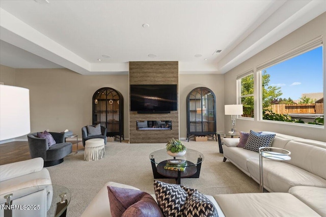 9822 Dyevera Ln, Reno, NV 89521 - living room featuring a large fireplace, carpet, and a tray ceiling