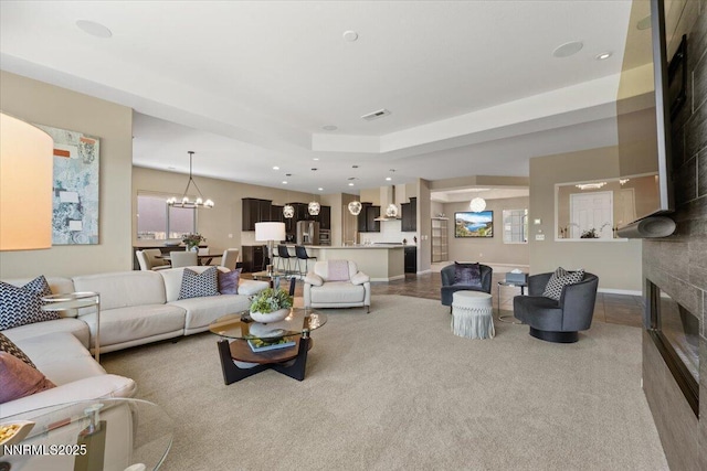 9822 Dyevera Ln, Reno, NV 89521 - carpeted living room with a glass covered fireplace, a chandelier, recessed lighting, baseboards, and plenty of natural light
