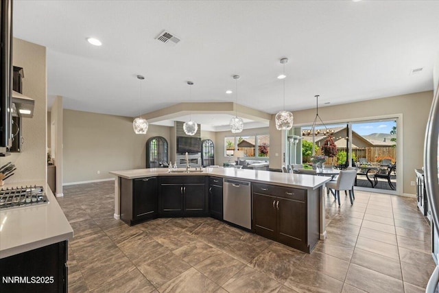 9822 Dyevera Ln, Reno, NV 89521 - kitchen featuring appliances with stainless steel finishes, light countertops, a chandelier, recessed lighting, and open floor plan