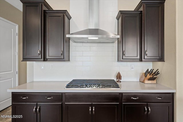 9822 Dyevera Ln, Reno, NV 89521 - kitchen with wall chimney range hood, backsplash, and light countertops