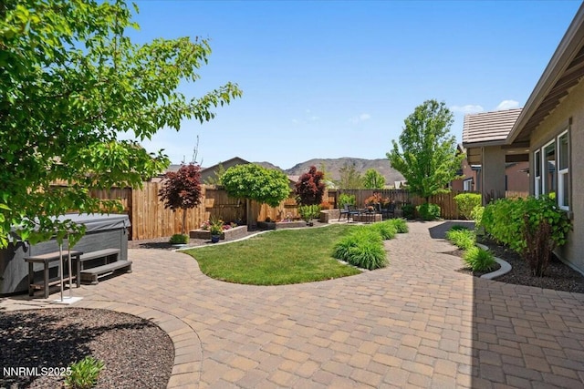 9822 Dyevera Ln, Reno, NV 89521 - view of yard featuring a patio, a hot tub, and a mountain view
