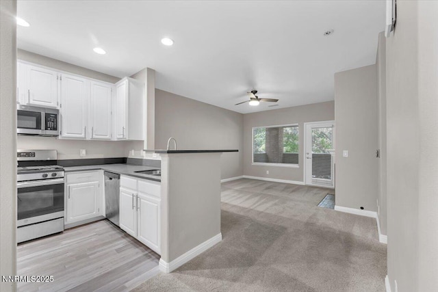 900 S Meadows Pkwy Unit 5222, Reno, NV 89521 - kitchen with stainless steel appliances, ceiling fan, baseboards, white cabinets, and a sink