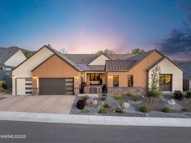 3060 Feathertop Dr, Reno, NV 89521 - modern farmhouse with a standing seam roof, an attached garage, driveway, stone siding, and metal roof