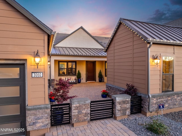 3060 Feathertop Dr, Reno, NV 89521 - exterior entry at dusk featuring a porch, a standing seam roof, and metal roof