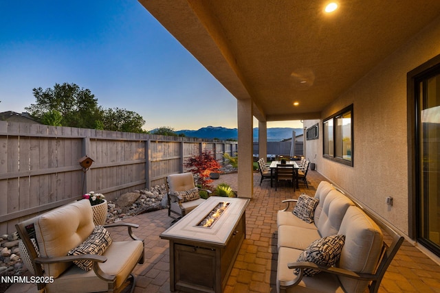 3060 Feathertop Dr, Reno, NV 89521 - fenced backyard with a patio area, outdoor dining space, an outdoor living space with a fire pit, and a mountain view