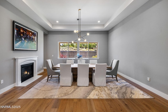 3060 Feathertop Dr, Reno, NV 89521 - dining room with wood finished floors, a chandelier, baseboards, a tray ceiling, and recessed lighting