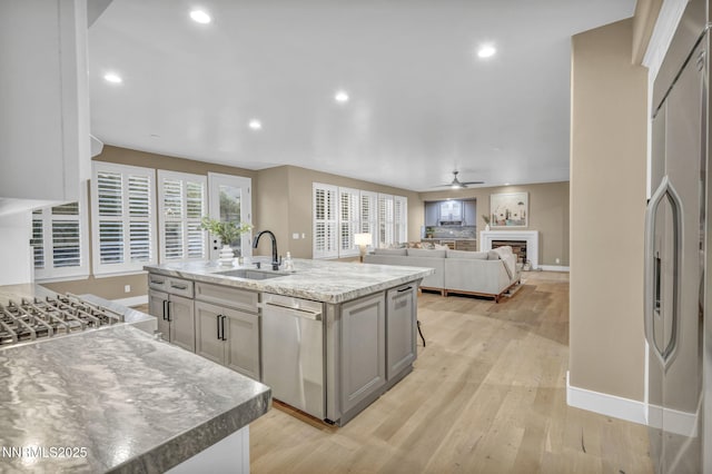 2965 Roundrock Ct, Reno, NV 89511 - kitchen with a sink, stainless steel appliances, baseboards, light wood finished floors, and ceiling fan