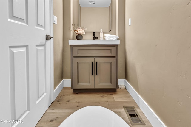 2965 Roundrock Ct, Reno, NV 89511 - bathroom featuring vanity, wood finished floors, baseboards, and a soaking tub