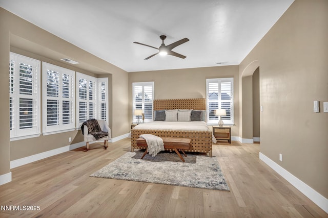 2965 Roundrock Ct, Reno, NV 89511 - bedroom with arched walkways, light wood-style floors, and baseboards