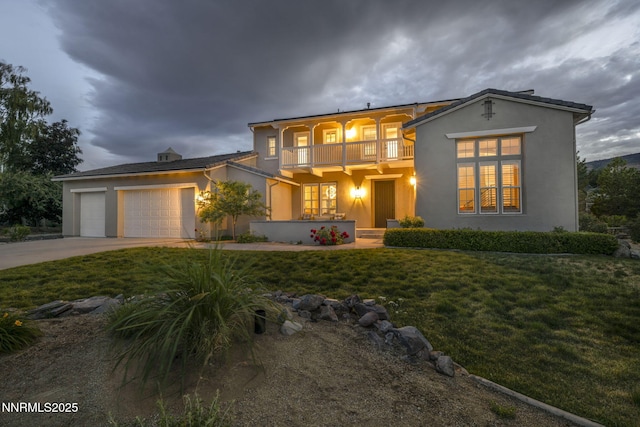 2965 Roundrock Ct, Reno, NV 89511 - view of front facade with a balcony, a garage, stucco siding, driveway, and a front yard