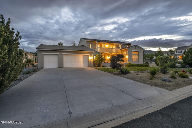 2965 Roundrock Ct, Reno, NV 89511 - view of front facade featuring a balcony, stucco siding, a garage, and concrete driveway