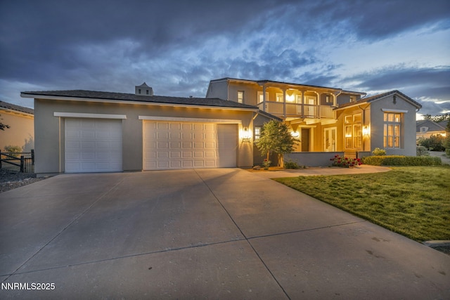2965 Roundrock Ct, Reno, NV 89511 - view of front of home with stucco siding, an attached garage, a balcony, and driveway