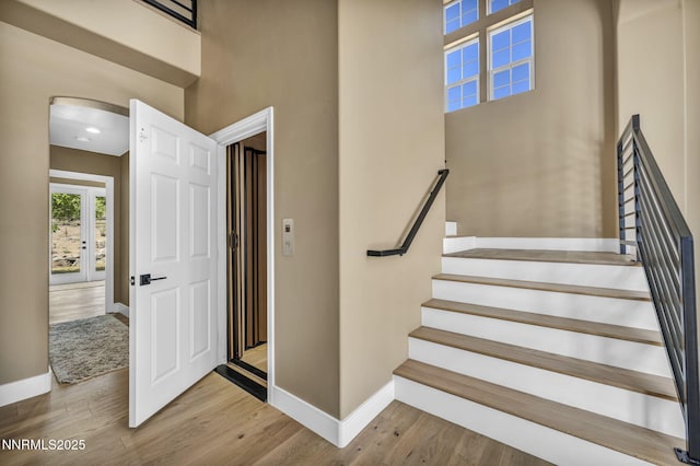 2965 Roundrock Ct, Reno, NV 89511 - stairs with baseboards, wood finished floors, arched walkways, and a high ceiling