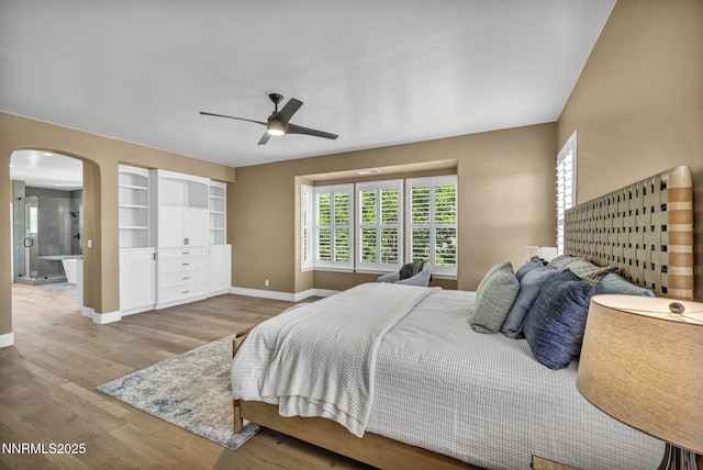 2965 Roundrock Ct, Reno, NV 89511 - bedroom featuring baseboards, arched walkways, wood finished floors, and a ceiling fan