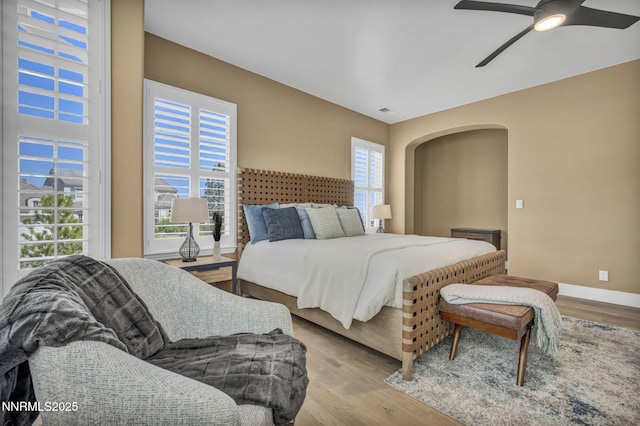 2965 Roundrock Ct, Reno, NV 89511 - bedroom featuring arched walkways, wood finished floors, baseboards, and ceiling fan