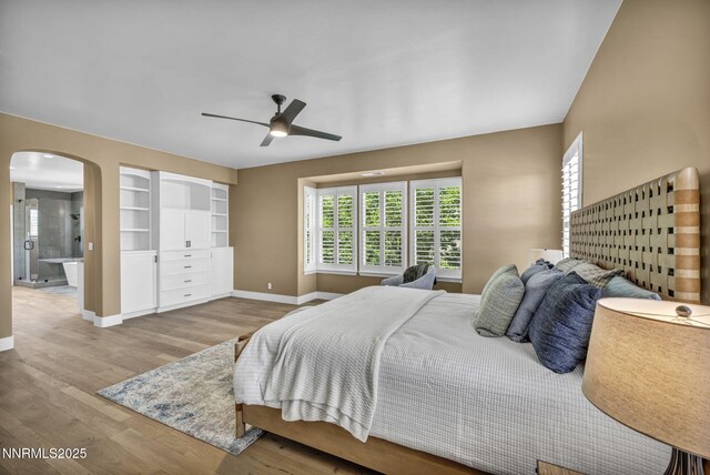 2965 Roundrock Ct, Reno, NV 89511 - bedroom featuring baseboards, arched walkways, wood finished floors, and a ceiling fan
