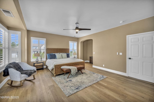 2965 Roundrock Ct, Reno, NV 89511 - bedroom with arched walkways, baseboards, light wood-style floors, and a ceiling fan