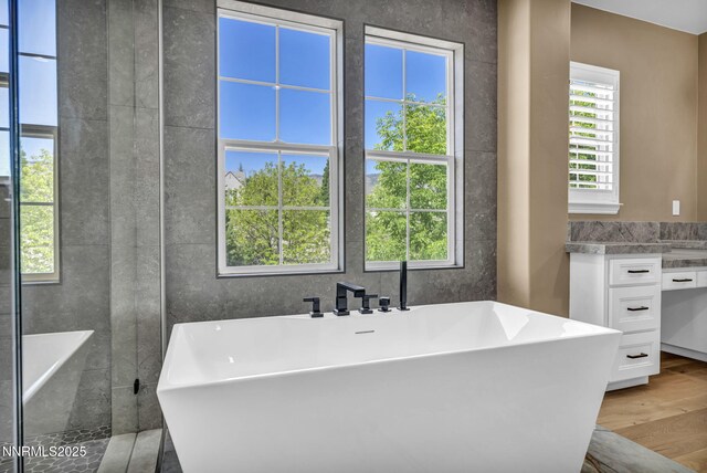 2965 Roundrock Ct, Reno, NV 89511 - full bath featuring wood finished floors, a freestanding tub, and vanity