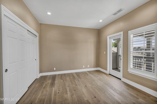 2965 Roundrock Ct, Reno, NV 89511 - unfurnished bedroom with baseboards, wood finished floors, recessed lighting, a closet, and access to exterior