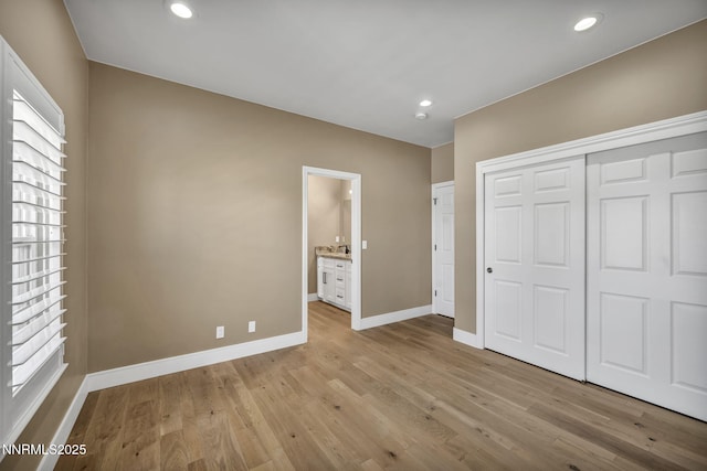 2965 Roundrock Ct, Reno, NV 89511 - unfurnished bedroom with baseboards, light wood-style flooring, a closet, connected bathroom, and recessed lighting
