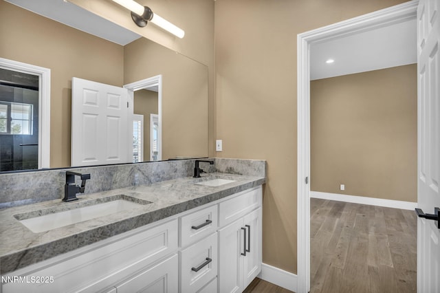 2965 Roundrock Ct, Reno, NV 89511 - full bathroom featuring wood finished floors, baseboards, and double vanity