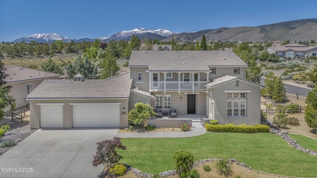 2965 Roundrock Ct, Reno, NV 89511 - view of front facade with a balcony, concrete driveway, an attached garage, stucco siding, and a mountain view