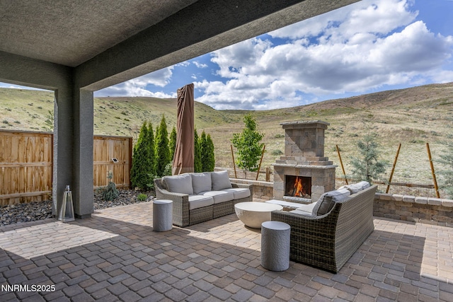9129 Wild Skies Way, Reno, NV 89523 - view of patio / terrace featuring a mountain view and an outdoor living space with a fireplace
