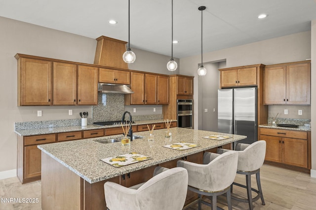 9129 Wild Skies Way, Reno, NV 89523 - kitchen featuring appliances with stainless steel finishes, brown cabinets, tasteful backsplash, and recessed lighting