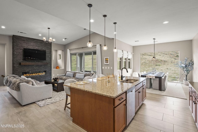 9129 Wild Skies Way, Reno, NV 89523 - kitchen featuring a sink, dishwasher, open floor plan, brown cabinetry, and light stone counters
