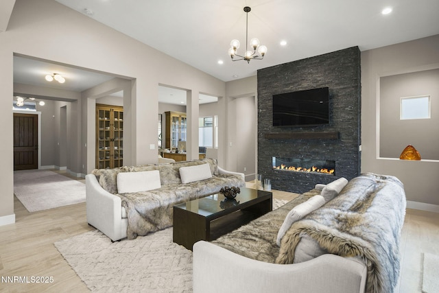 9129 Wild Skies Way, Reno, NV 89523 - living room featuring a chandelier, baseboards, a fireplace, light wood finished floors, and recessed lighting