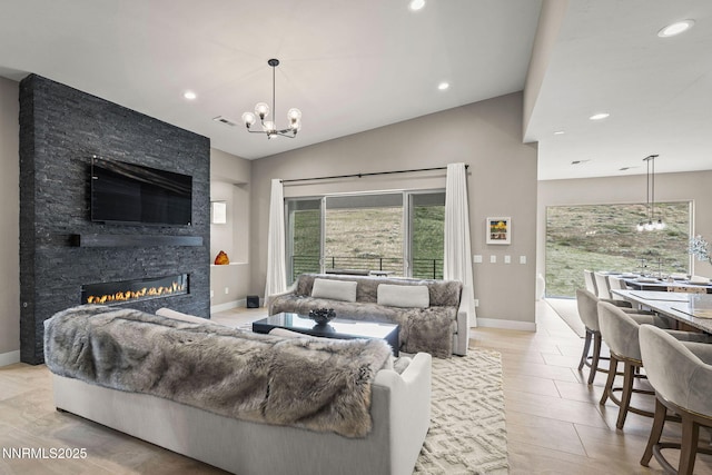 9129 Wild Skies Way, Reno, NV 89523 - living area featuring a chandelier, a fireplace, baseboards, vaulted ceiling, and recessed lighting