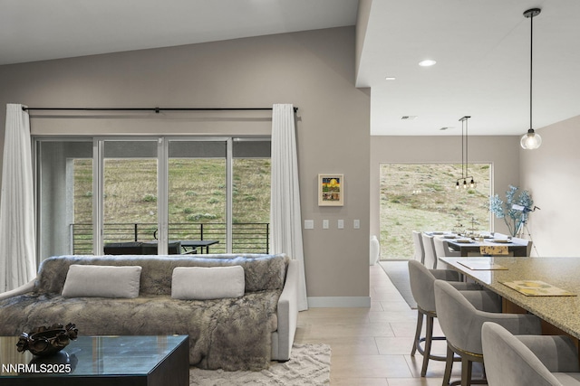 9129 Wild Skies Way, Reno, NV 89523 - living area featuring baseboards, healthy amount of natural light, light tile patterned floors, recessed lighting, and high vaulted ceiling