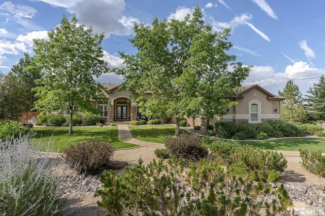 5330 Ventana Pkwy, Reno, NV 89511 - obstructed view of property with french doors, stucco siding, stone siding, and a front lawn