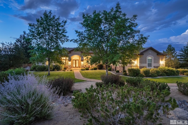 5330 Ventana Pkwy, Reno, NV 89511 - view of front facade with stucco siding, french doors, and a front yard
