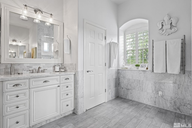 5330 Ventana Pkwy, Reno, NV 89511 - bathroom featuring tile walls, vanity, wainscoting, and wood finished floors