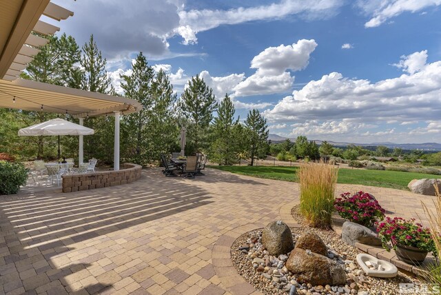 5330 Ventana Pkwy, Reno, NV 89511 - view of patio / terrace with outdoor dining space, a pergola, and a mountain view