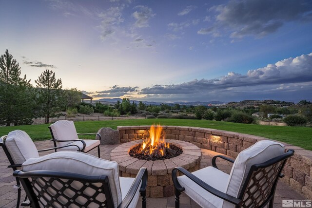 5330 Ventana Pkwy, Reno, NV 89511 - patio terrace at dusk with an outdoor fire pit, a yard, and a patio area