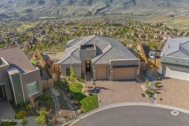 9220 Wild Skies Ct, Reno, NV 89523 - view of front of home with a garage, driveway, stucco siding, and a mountain view
