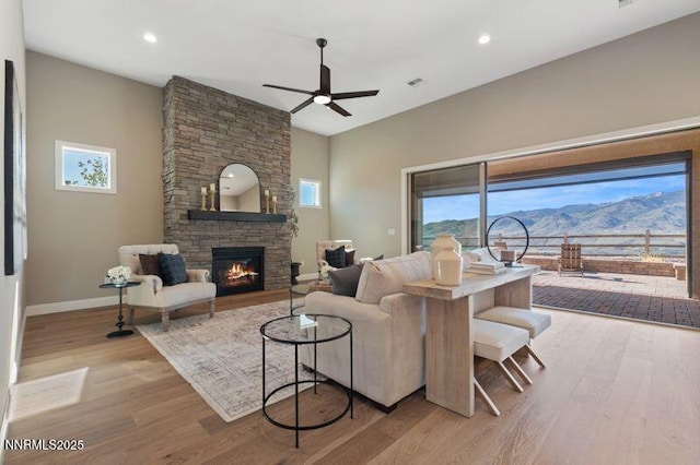 9220 Wild Skies Ct, Reno, NV 89523 - living room with a ceiling fan, plenty of natural light, a stone fireplace, wood finished floors, and recessed lighting