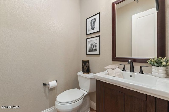 9220 Wild Skies Ct, Reno, NV 89523 - bathroom with vanity, toilet, baseboards, and a textured wall