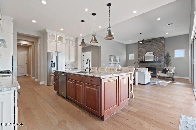 9220 Wild Skies Ct, Reno, NV 89523 - kitchen featuring ceiling fan, stainless steel appliances, a sink, light wood-type flooring, and white cabinets