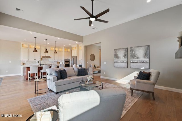 9220 Wild Skies Ct, Reno, NV 89523 - living area with a ceiling fan, light wood-type flooring, baseboards, and recessed lighting